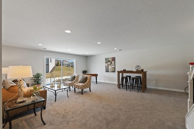 living room featuring a textured ceiling and dark colored carpet