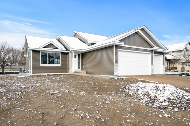 view of front of property with an attached garage and central air condition unit