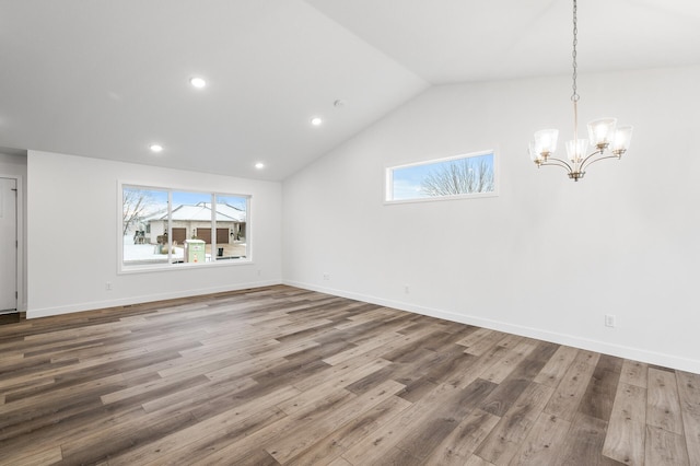 interior space with hardwood / wood-style floors, a chandelier, and lofted ceiling