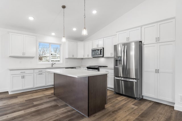 kitchen featuring white cabinetry, sink, hanging light fixtures, stainless steel appliances, and dark hardwood / wood-style floors