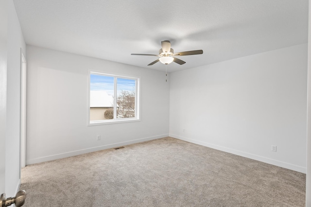 carpeted empty room featuring ceiling fan