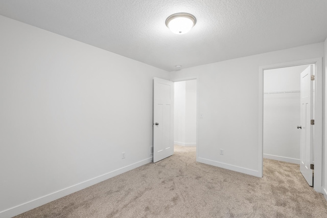 carpeted spare room featuring a textured ceiling