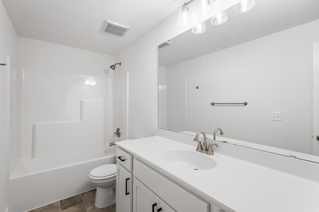 full bathroom with bathtub / shower combination, vanity, a textured ceiling, tile patterned flooring, and toilet