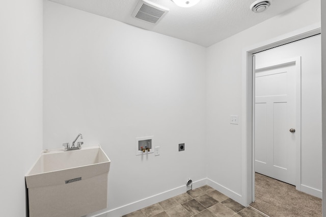 laundry area with sink, hookup for an electric dryer, hookup for a washing machine, a textured ceiling, and light carpet