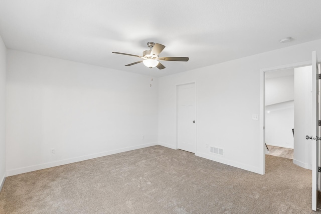 unfurnished bedroom with a ceiling fan, carpet, visible vents, and baseboards