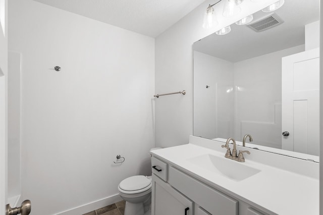 bathroom featuring baseboards, visible vents, vanity, and toilet