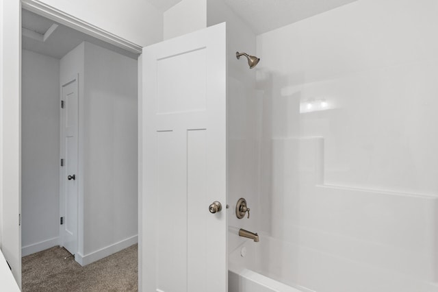 bathroom featuring shower / bathtub combination and baseboards