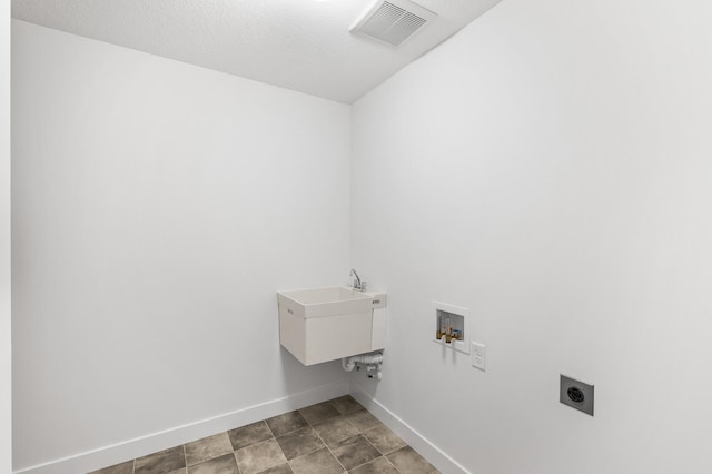 washroom featuring hookup for a washing machine, visible vents, electric dryer hookup, laundry area, and baseboards