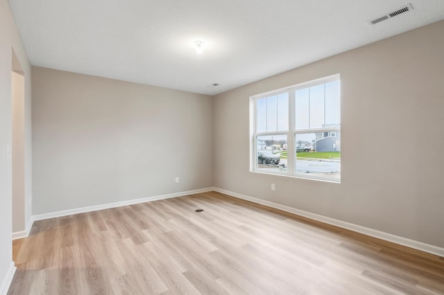 spare room with light hardwood / wood-style flooring