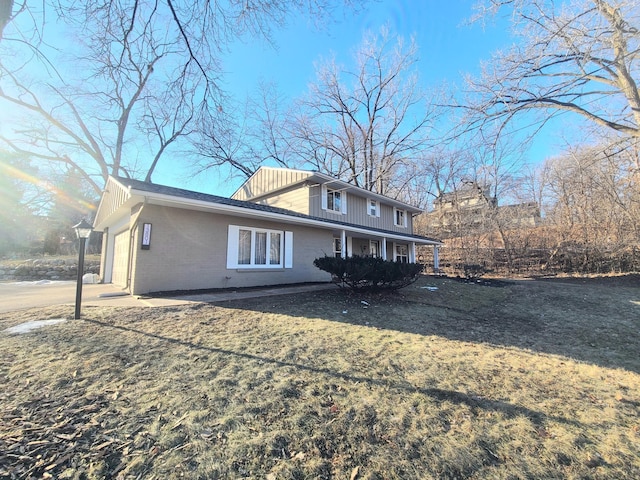 rear view of property featuring a garage