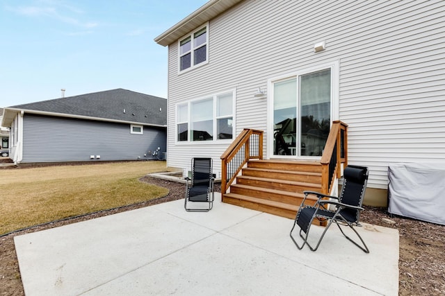 back of property with a yard and a patio