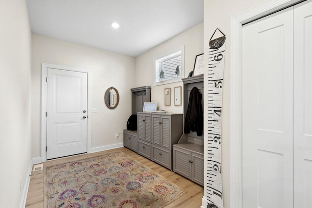 mudroom with light hardwood / wood-style floors