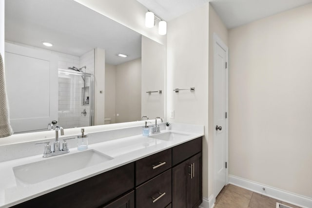 bathroom featuring vanity, tile patterned floors, and a shower with shower door