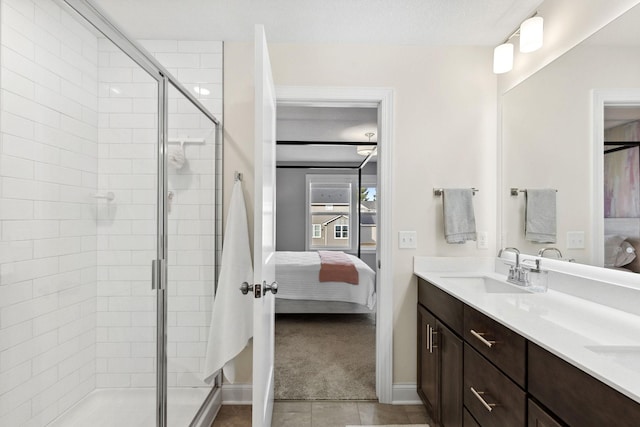 bathroom with tile patterned flooring, vanity, and an enclosed shower