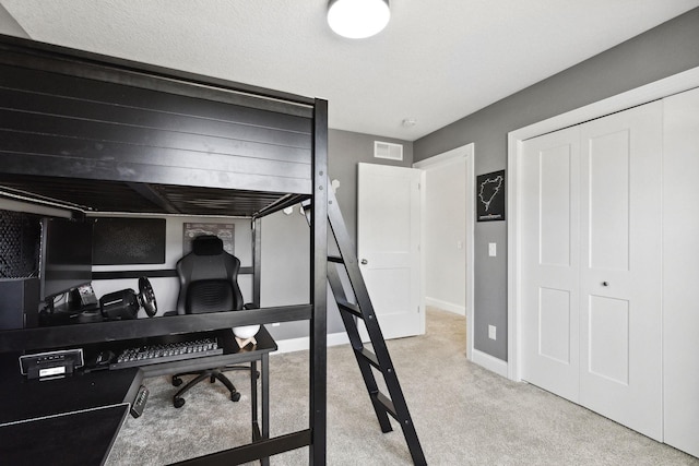 carpeted bedroom featuring a closet