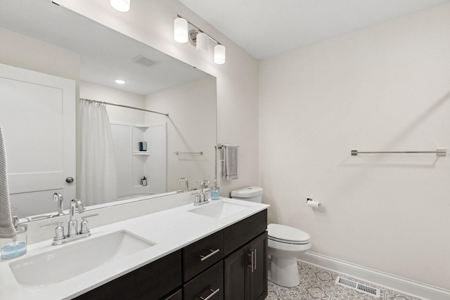 bathroom featuring tile patterned floors, vanity, toilet, and walk in shower