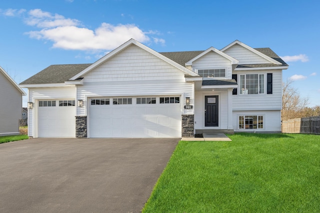 view of front of home featuring a front lawn and a garage