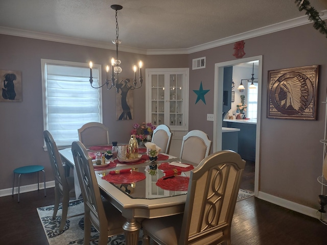 dining area with a chandelier, baseboards, dark wood finished floors, and crown molding