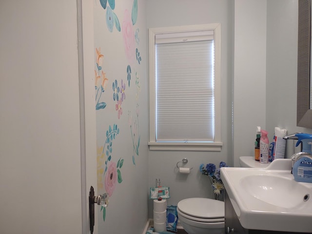 bathroom featuring toilet and vanity