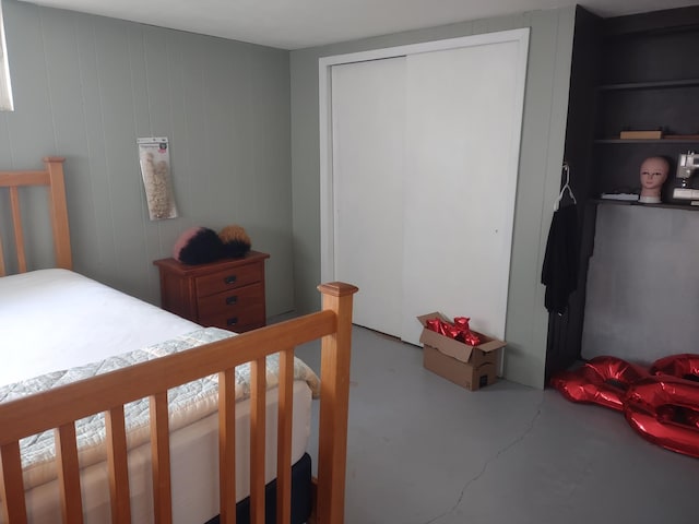 bedroom featuring a closet and concrete flooring