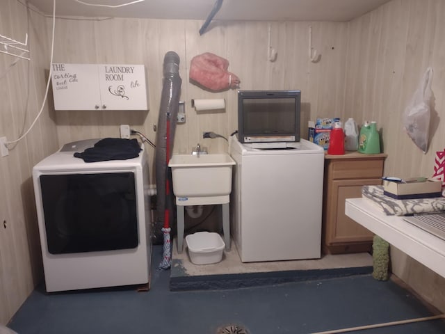 laundry room with cabinet space, washer / clothes dryer, and a sink