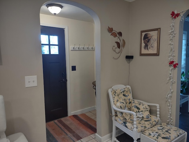 entrance foyer with arched walkways and baseboards