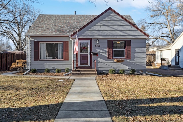 bungalow-style home featuring a front yard