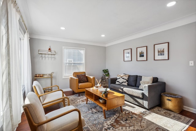 living room featuring hardwood / wood-style flooring and ornamental molding