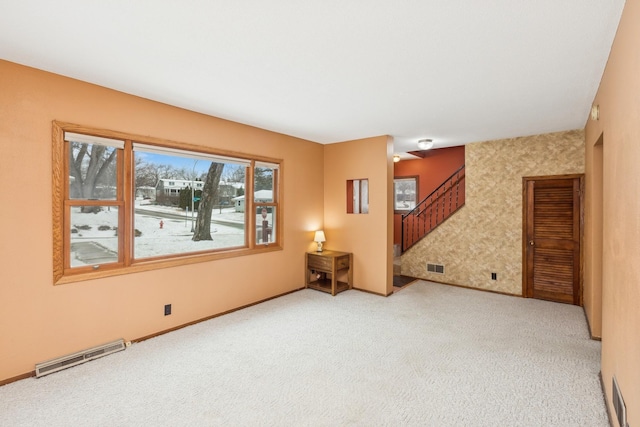 unfurnished room with light colored carpet