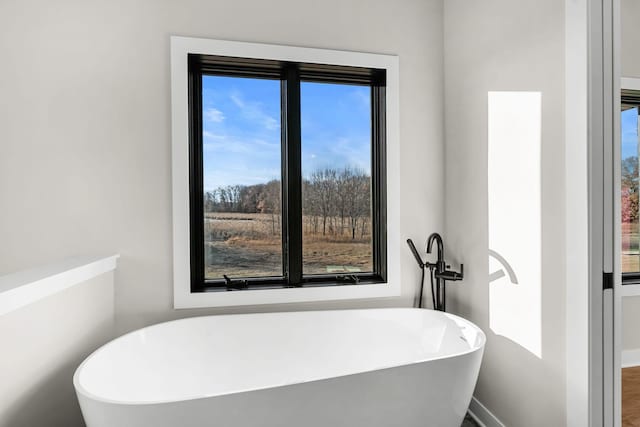 bathroom with a tub to relax in