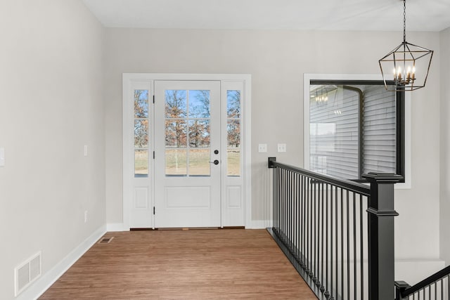 foyer with a chandelier and light hardwood / wood-style floors