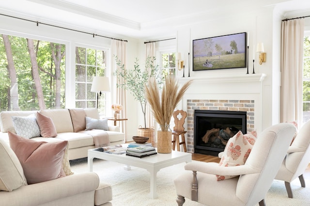 sunroom / solarium featuring a raised ceiling and a fireplace