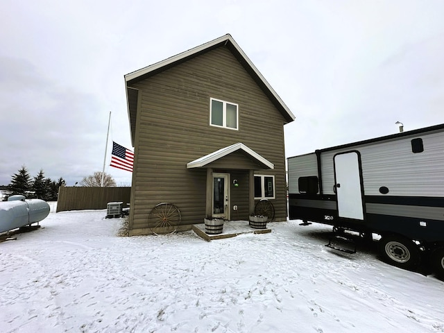 view of snow covered rear of property