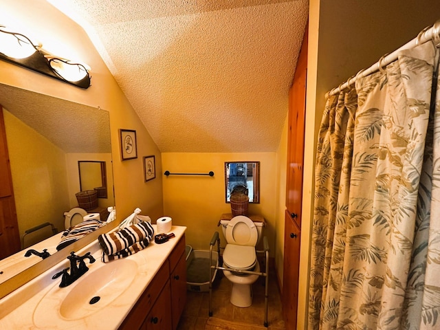 bathroom with lofted ceiling, vanity, tile patterned flooring, toilet, and a textured ceiling