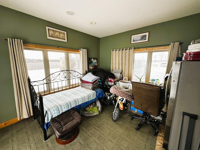 bedroom featuring stainless steel refrigerator