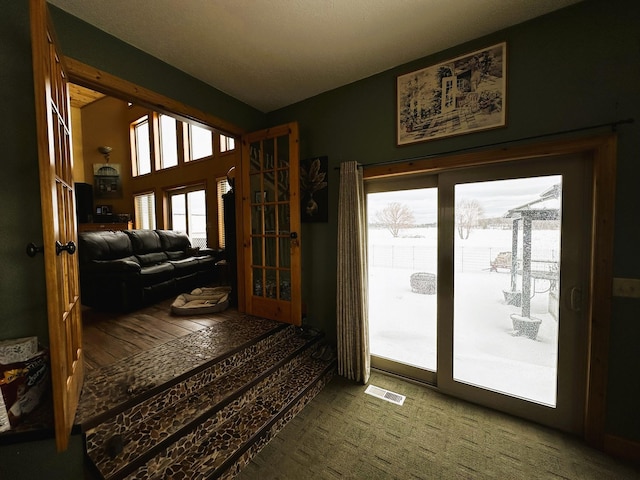 entryway with french doors, carpet, and plenty of natural light