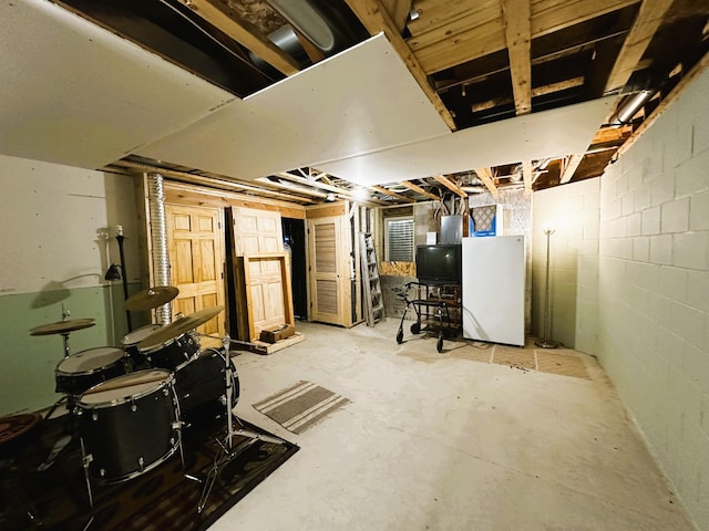 basement featuring white fridge