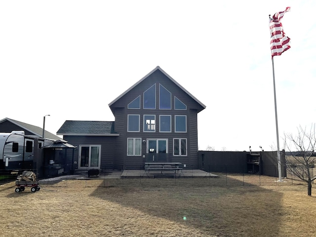 rear view of house featuring central AC unit, a patio, a yard, and fence