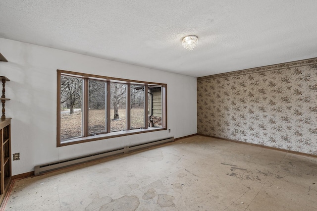 spare room with a textured ceiling and baseboard heating