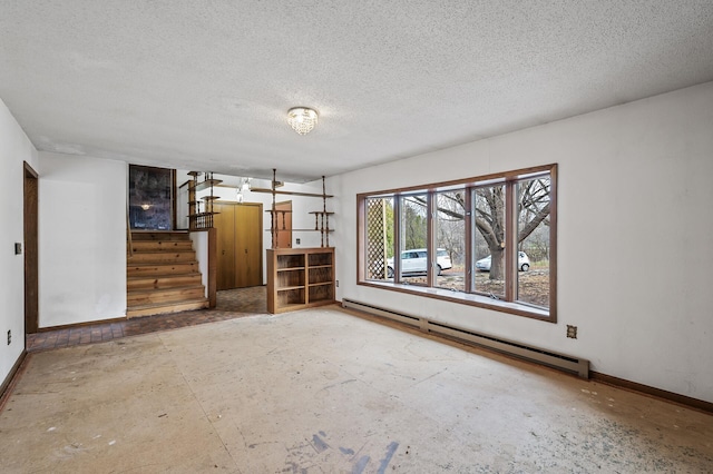 empty room with a textured ceiling and a baseboard radiator