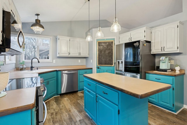 kitchen featuring white cabinetry, hanging light fixtures, a center island, and appliances with stainless steel finishes