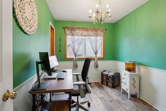 office with a notable chandelier, a textured ceiling, and light hardwood / wood-style flooring