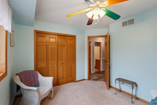 sitting room with light colored carpet and ceiling fan