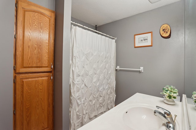 bathroom featuring sink and a textured ceiling