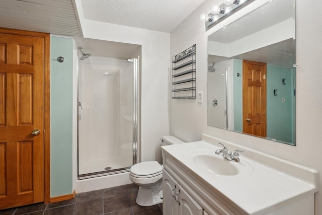 bathroom featuring vanity, walk in shower, toilet, tile patterned floors, and a textured ceiling