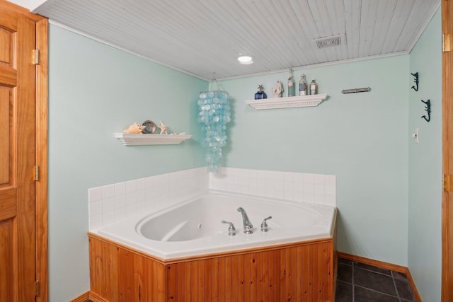 bathroom with tile patterned flooring and a bathtub