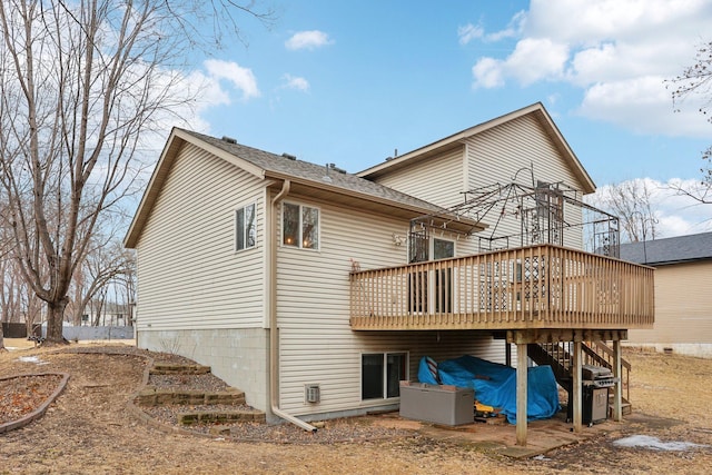 back of property with a wooden deck