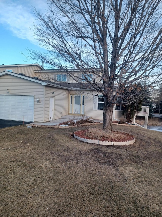 ranch-style home featuring a front lawn and a garage