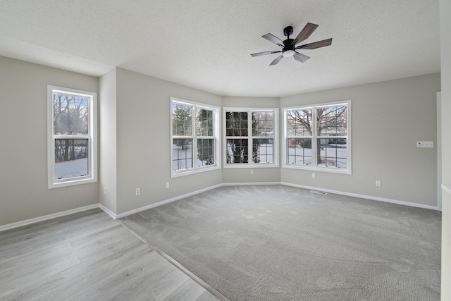 unfurnished room with a textured ceiling and ceiling fan