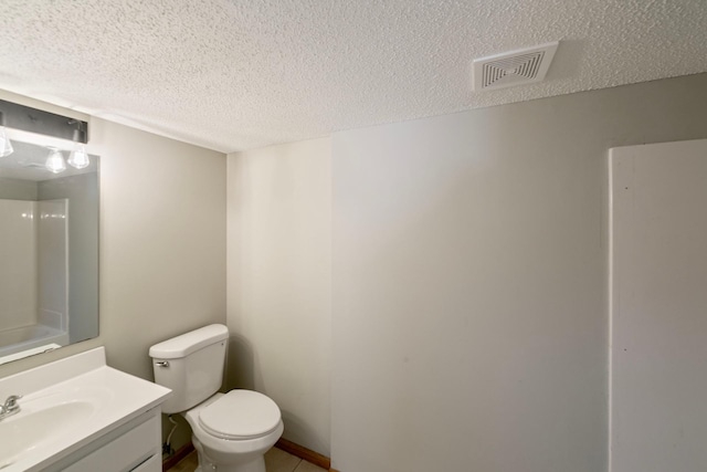 bathroom featuring a textured ceiling, toilet, vanity, and tile patterned flooring